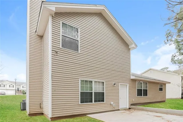 a view of a house with a door and a yard