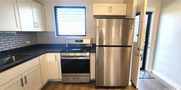 a kitchen with a refrigerator and a stove