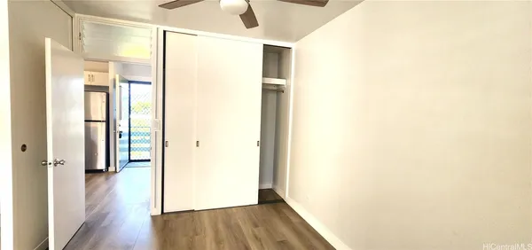 a view of a hallway with wooden floor