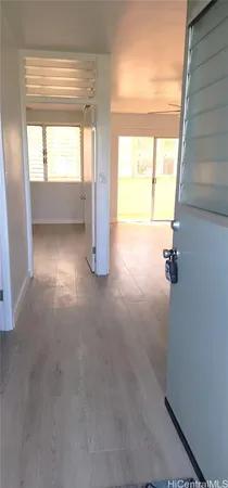 a view of an empty room and a window