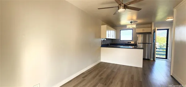 a view of kitchen with sink and wooden floor