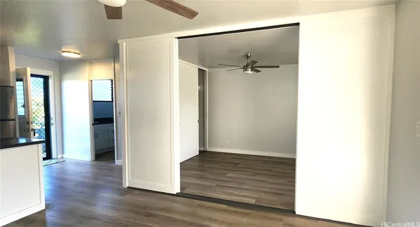 a view of a hallway with wooden floor