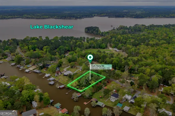 an aerial view of a houses with a lake view