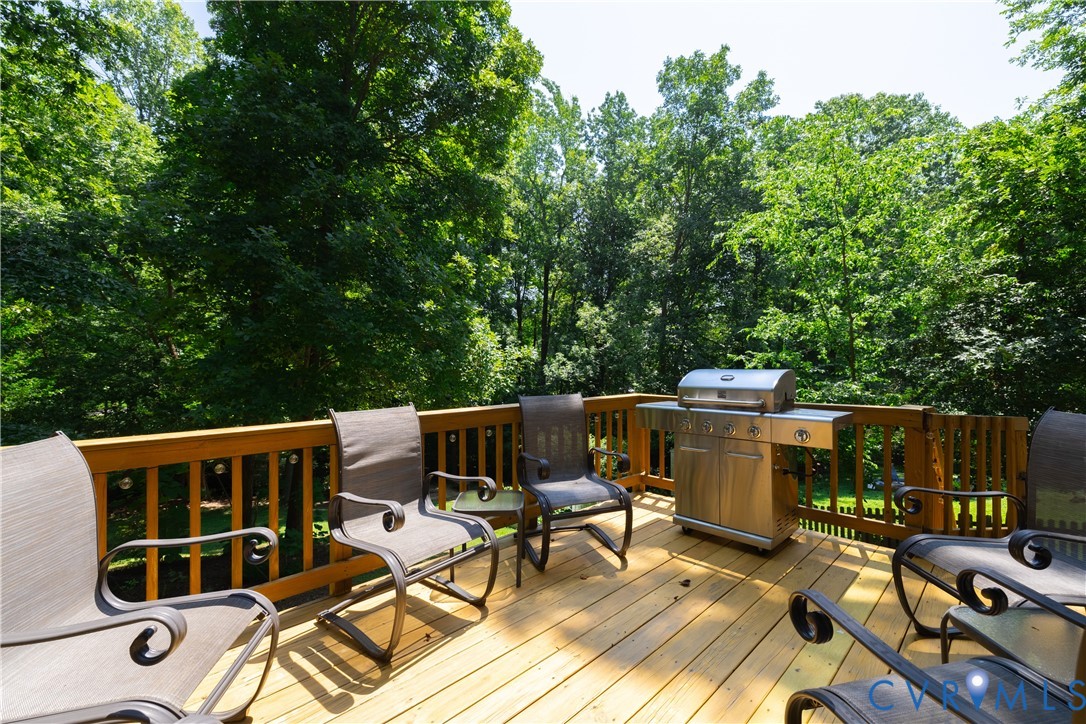 4501 Foxwood Road Chester, VA 23831 - Photo 30 of 42 Spacious outdoor wood deck with a natural wood rai
