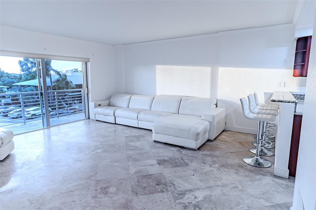 2900 Northeast 30th Street, Unit 3F Fort Lauderdale, FL 33306 - Photo 15 of 30 a living room with furniture a rug and white walls