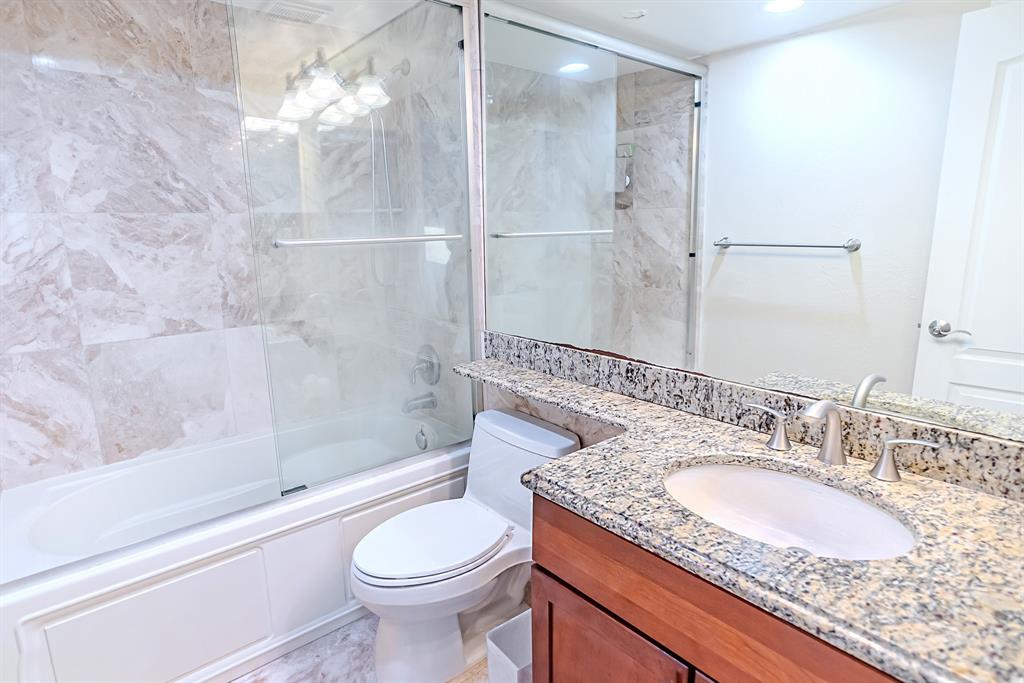2900 Northeast 30th Street, Unit 3F Fort Lauderdale, FL 33306 - Photo 17 of 30 a bathroom with a granite countertop sink toilet and shower