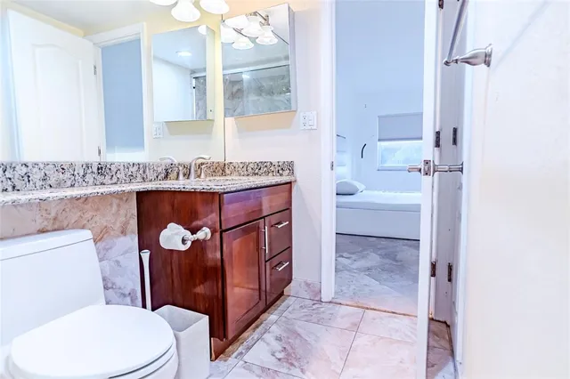 a bathroom with a sink a toilet and bathtub