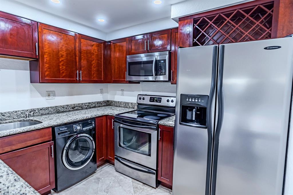 2900 Northeast 30th Street, Unit 3F Fort Lauderdale, FL 33306 - Photo 2 of 30 a kitchen with a stove and a microwave