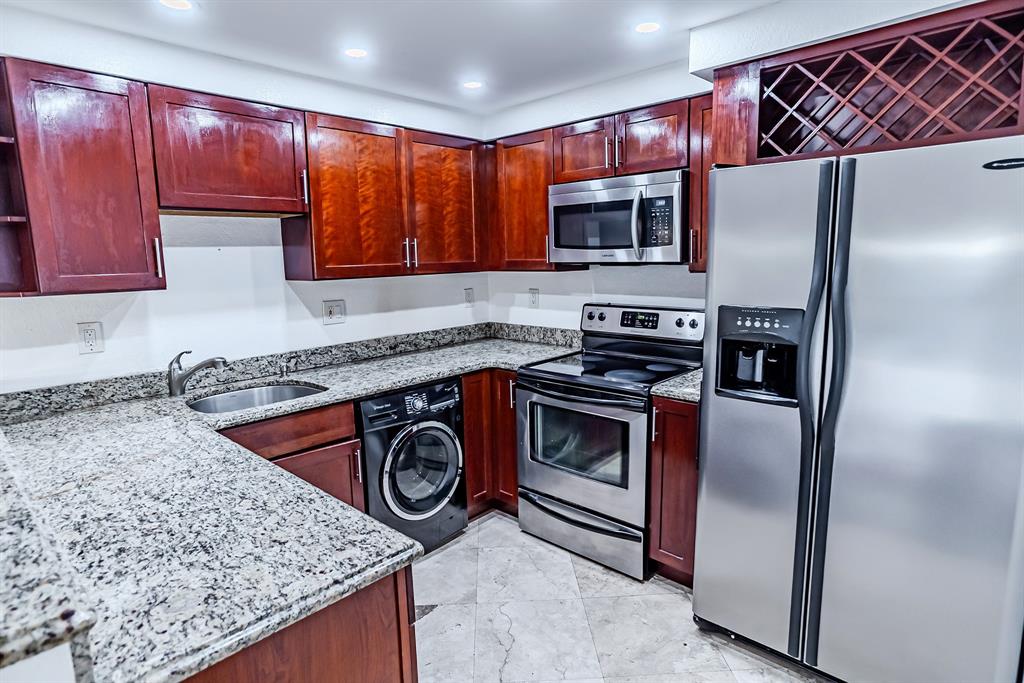 2900 Northeast 30th Street, Unit 3F Fort Lauderdale, FL 33306 - Photo 3 of 30 a kitchen with stainless steel appliances granite countertop a stove a refrigerator and a sink