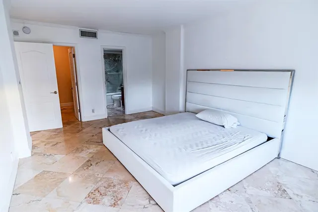 a bedroom with a bed and a mirror