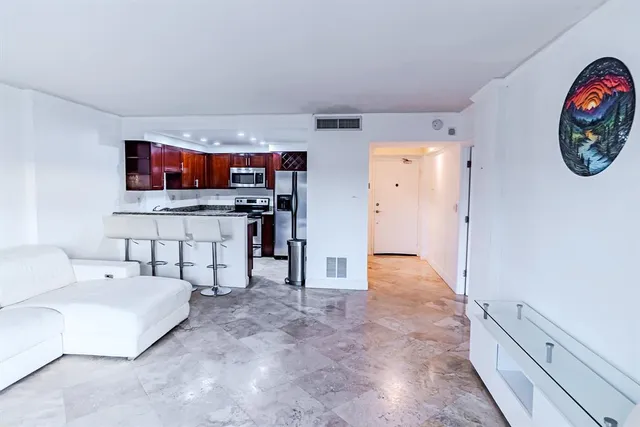 a view of living room filled with furniture and window