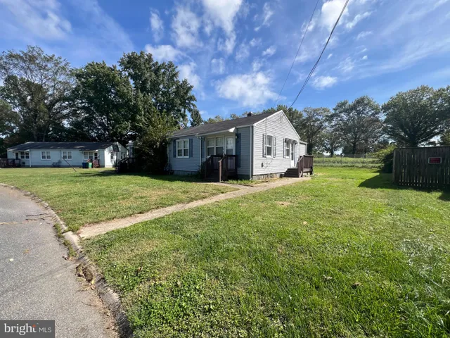a front view of a house with yard and green space