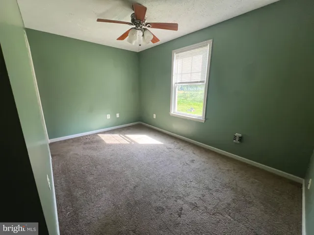 a view of room with window and ceiling fan