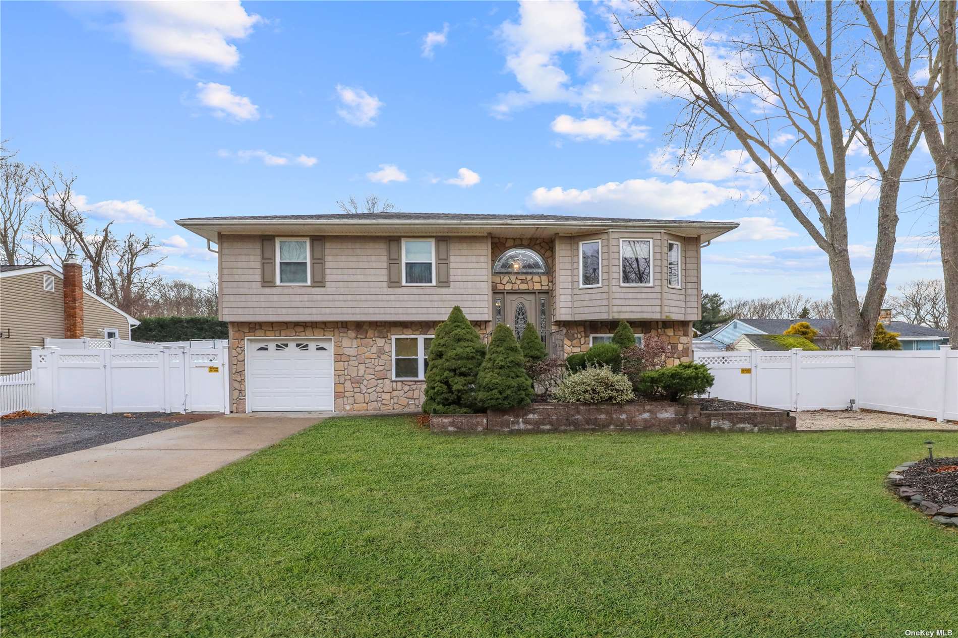 226 Horseblock Road Farmingville, NY 11738 - Photo 1 of 1 a front view of a house with a yard and garage