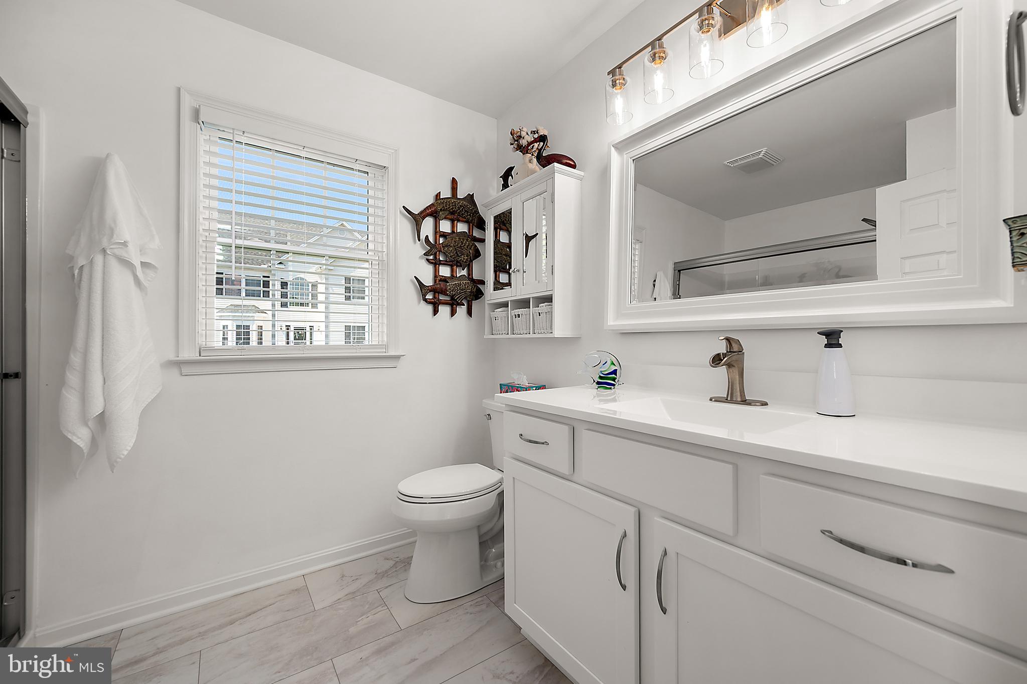6098 Tarry Town Road Salisbury, MD 21801 - Photo 29 of 60 a bathroom with a toilet sink and mirror
