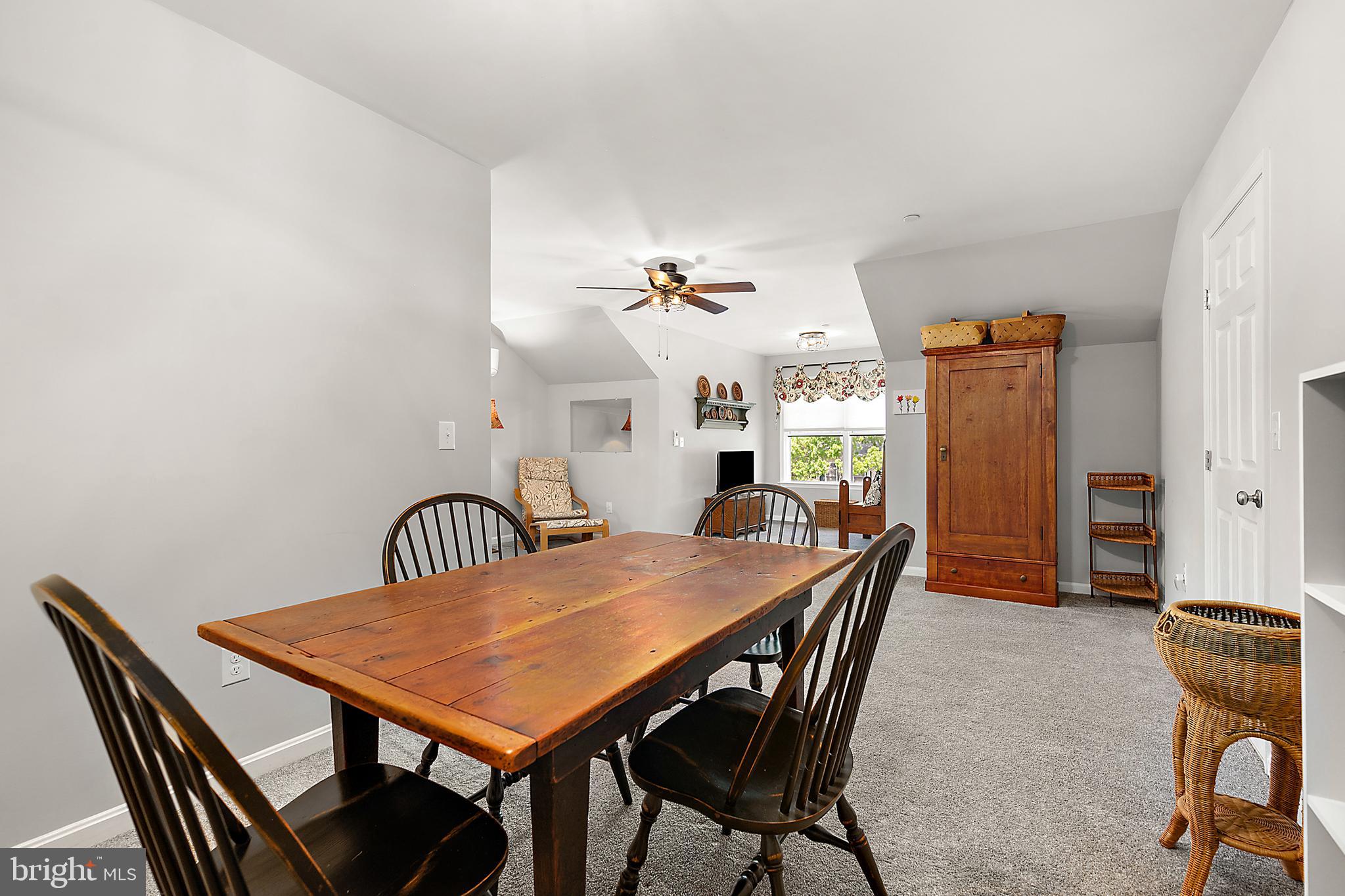 6098 Tarry Town Road Salisbury, MD 21801 - Photo 42 of 60 a view of a dining room and livingroom with furniture wooden floor a rug and a chandelier