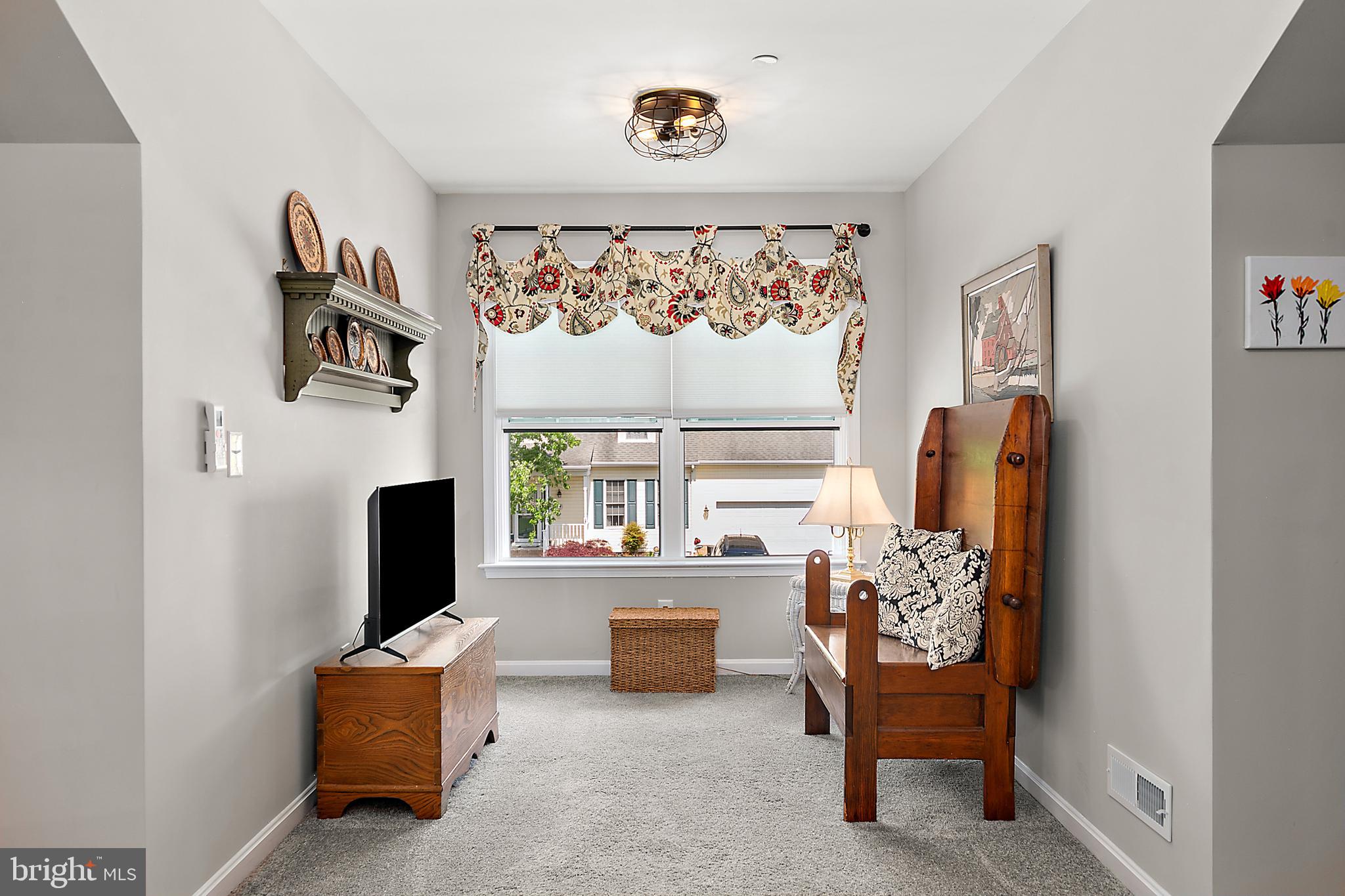 6098 Tarry Town Road Salisbury, MD 21801 - Photo 44 of 60 a living room with furniture a rug and a window