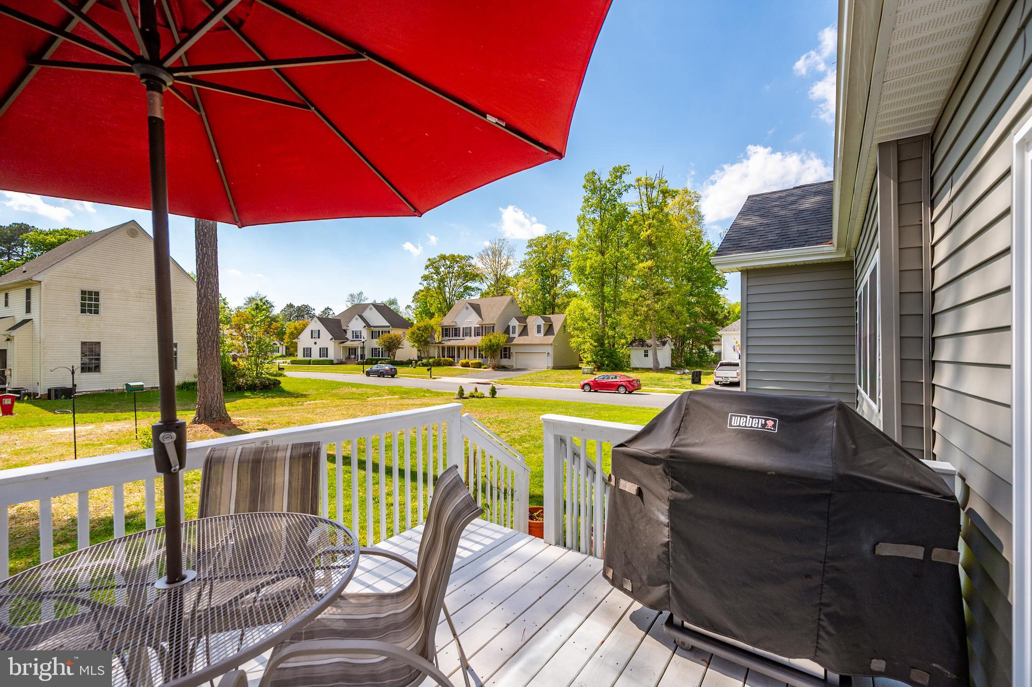 6098 Tarry Town Road Salisbury, MD 21801 - Photo 50 of 60 a view of a patio with table and chairs under an umbrella