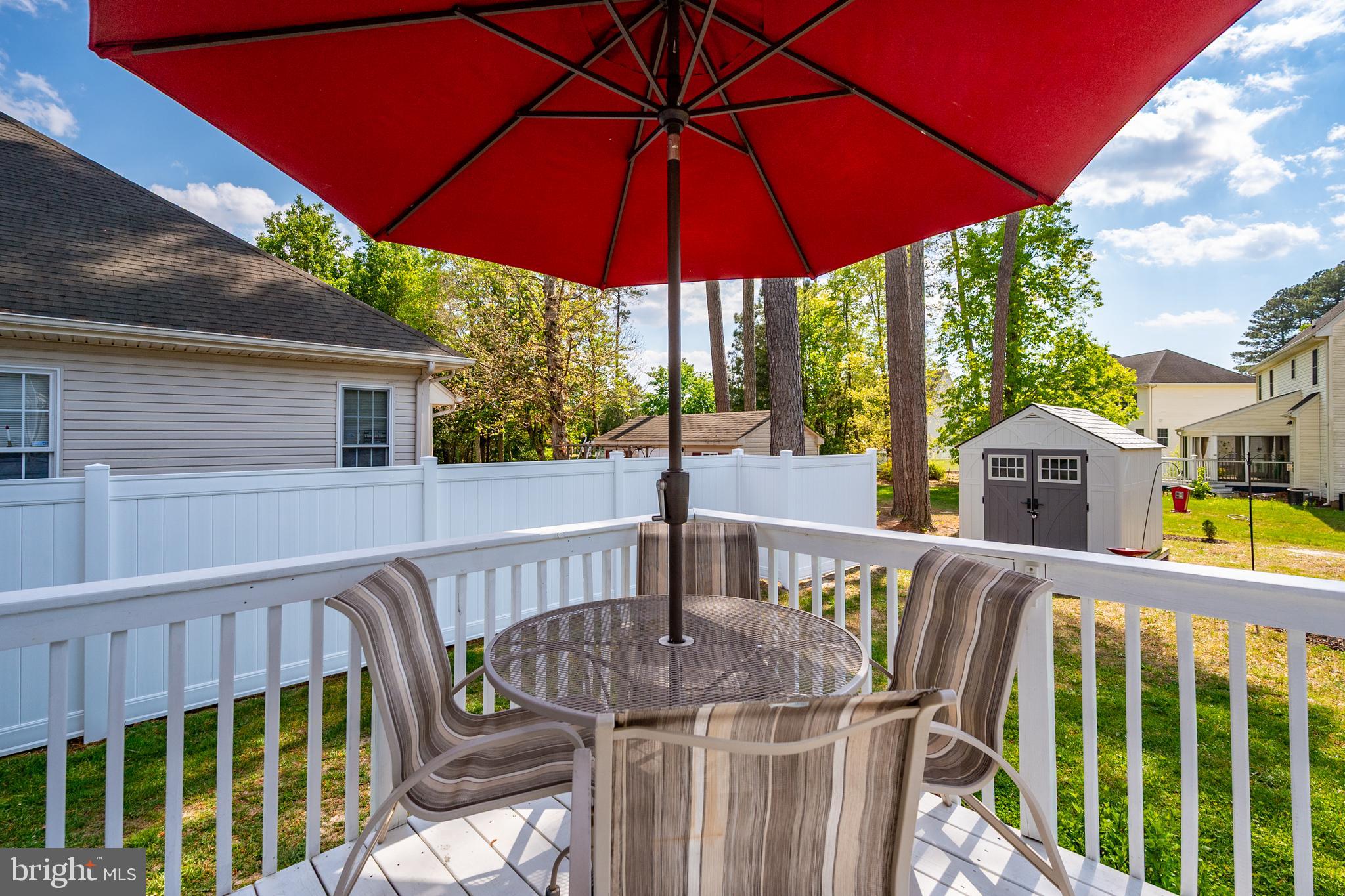 6098 Tarry Town Road Salisbury, MD 21801 - Photo 51 of 60 a view of a roof deck with table and chairs under an umbrella