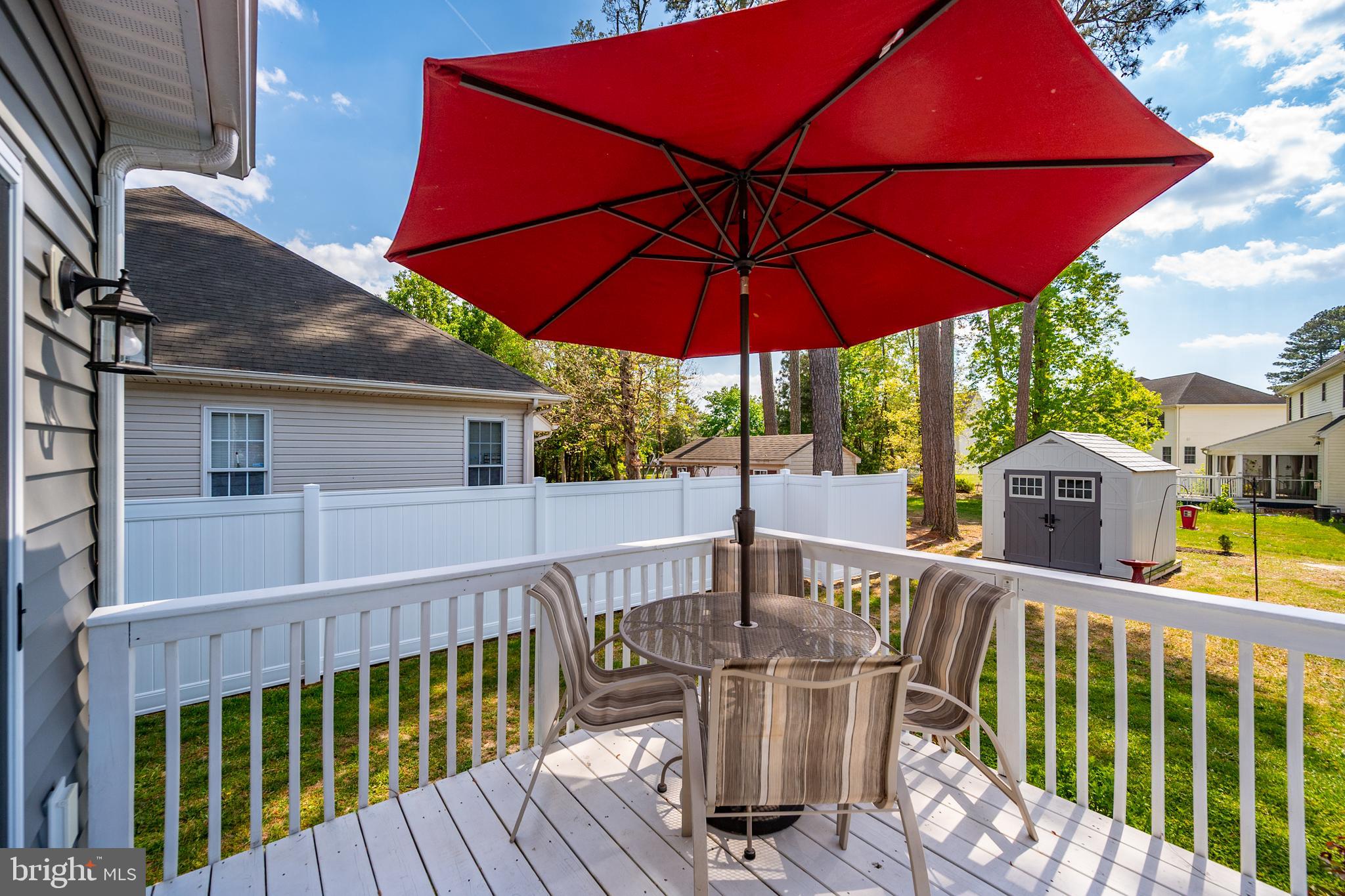 6098 Tarry Town Road Salisbury, MD 21801 - Photo 7 of 60 a view of a deck with a table and chairs under an umbrella