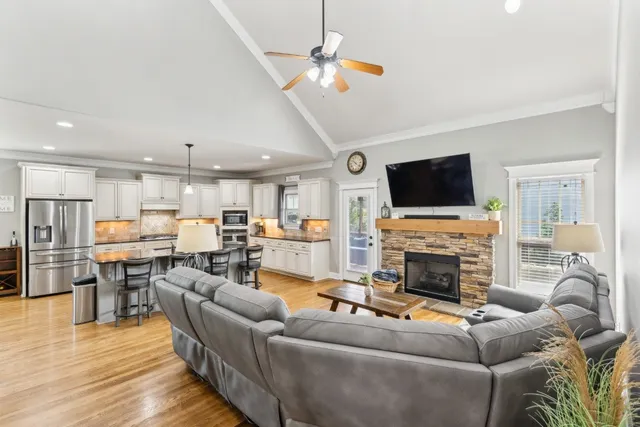 a living room with furniture a fireplace and a flat screen tv
