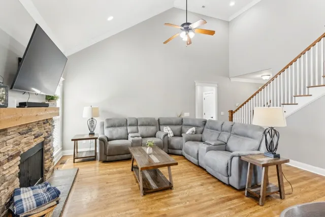 a living room with furniture fireplace and a flat screen tv