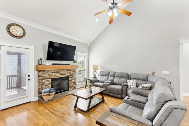 a living room with furniture a fireplace and a flat screen tv