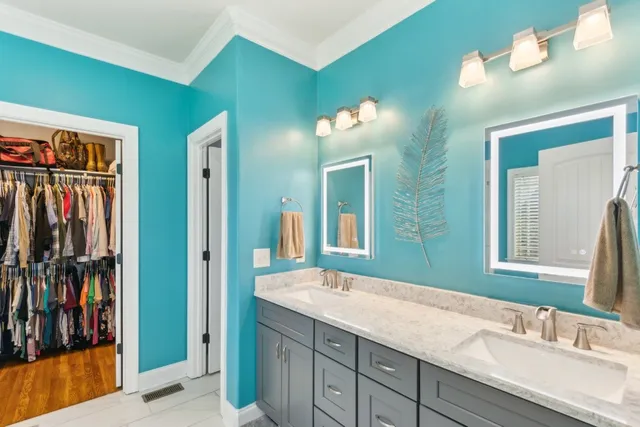 a bathroom with a double vanity sink and a mirror