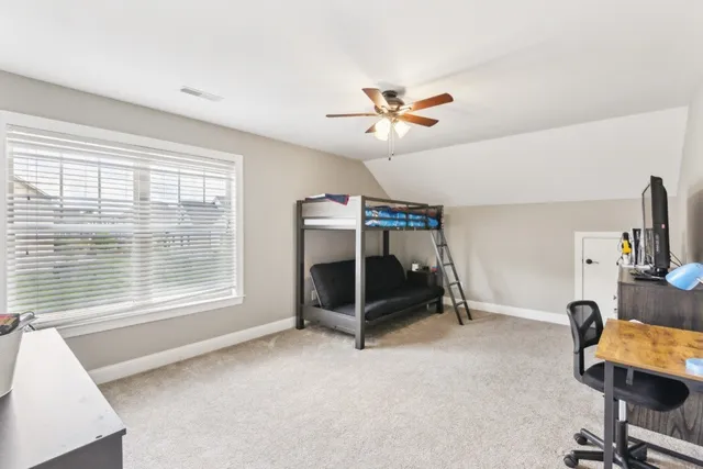 a bedroom with furniture and a window