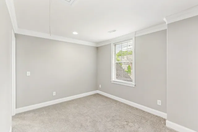 a living room with furniture ceiling fan and a window