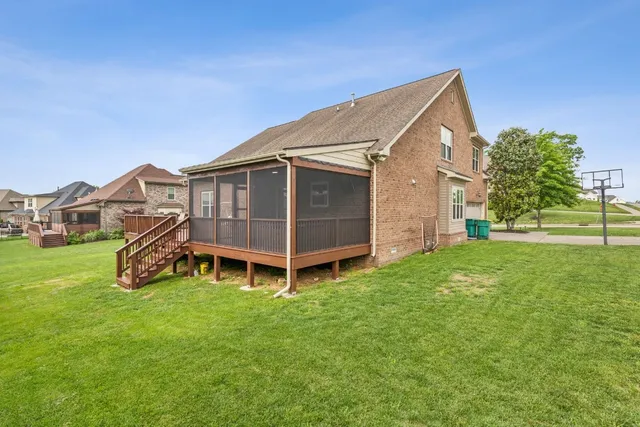 a view of a porch with furniture and a yard