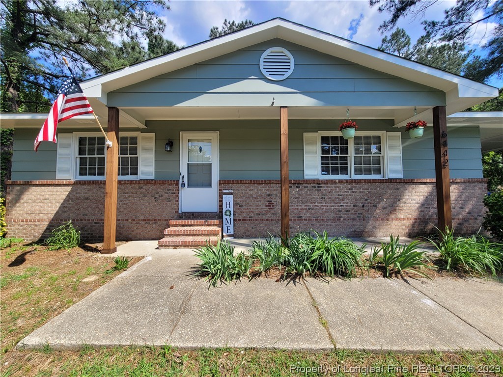 6442 Green Meadow Road Fayetteville, NC 28304 - Photo 1 of 48 a front view of a house with garden