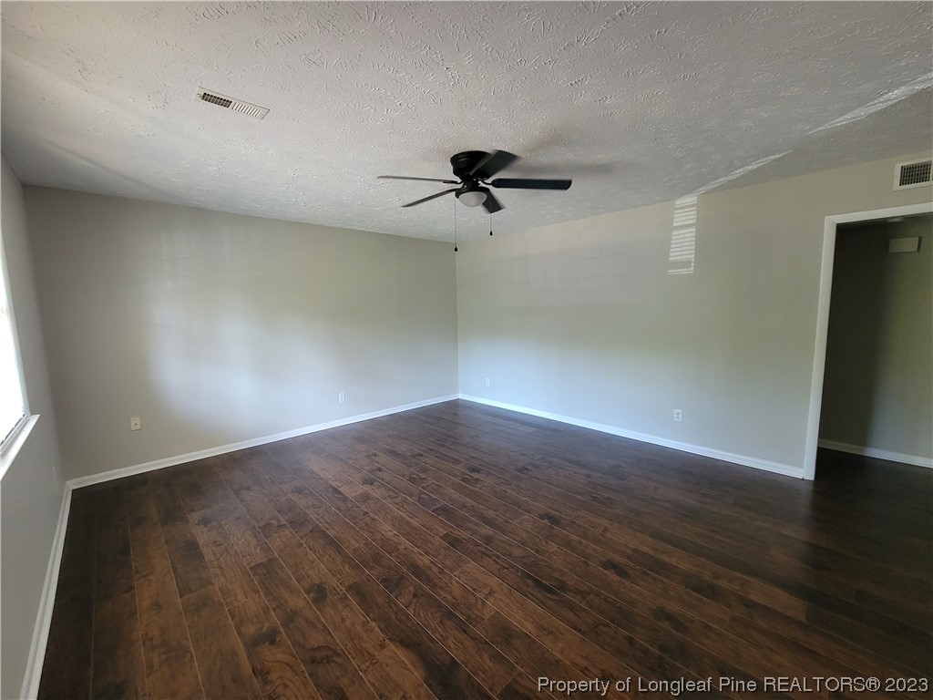 6442 Green Meadow Road Fayetteville, NC 28304 - Photo 11 of 48 a view of a room with wooden floor and a ceiling fan