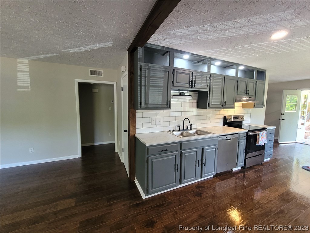 6442 Green Meadow Road Fayetteville, NC 28304 - Photo 13 of 48 a kitchen with stainless steel appliances granite countertop a sink stove and refrigerator