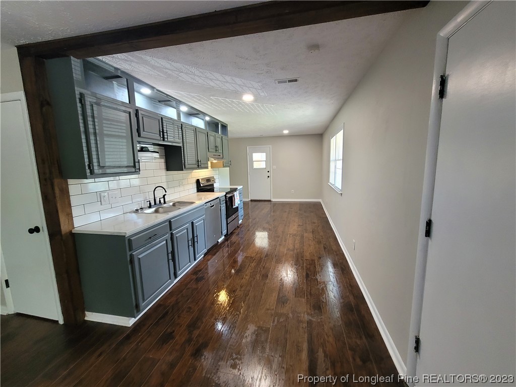 6442 Green Meadow Road Fayetteville, NC 28304 - Photo 14 of 48 a large kitchen with a sink and wooden floor