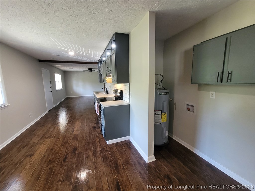 6442 Green Meadow Road Fayetteville, NC 28304 - Photo 15 of 48 a view of a hallway to an empty room and wooden floor