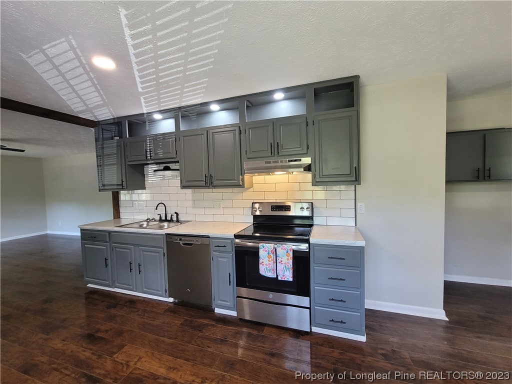 6442 Green Meadow Road Fayetteville, NC 28304 - Photo 17 of 48 a kitchen with stainless steel appliances granite countertop a stove and a sink