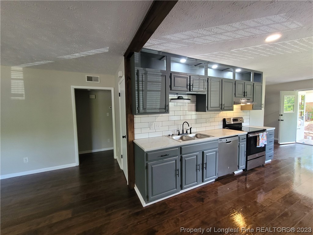6442 Green Meadow Road Fayetteville, NC 28304 - Photo 18 of 48 a kitchen with a sink cabinets and wooden floor