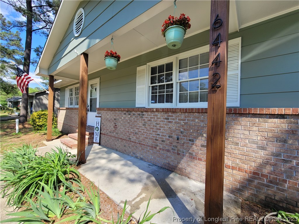 6442 Green Meadow Road Fayetteville, NC 28304 - Photo 2 of 48 a front view of a house with a porch