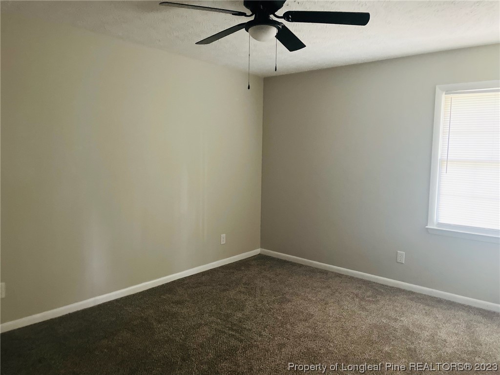 6442 Green Meadow Road Fayetteville, NC 28304 - Photo 28 of 48 an empty room with a window and a fan