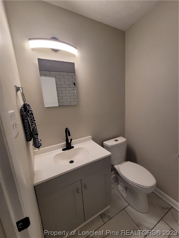6442 Green Meadow Road Fayetteville, NC 28304 - Photo 39 of 48 a bathroom with a toilet a sink and mirror