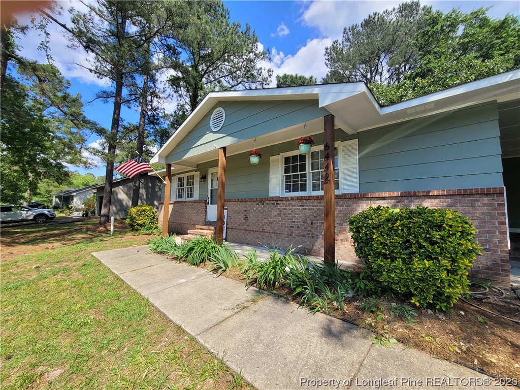 6442 Green Meadow Road Fayetteville, NC 28304 - Photo 4 of 48 a front view of a house with garden