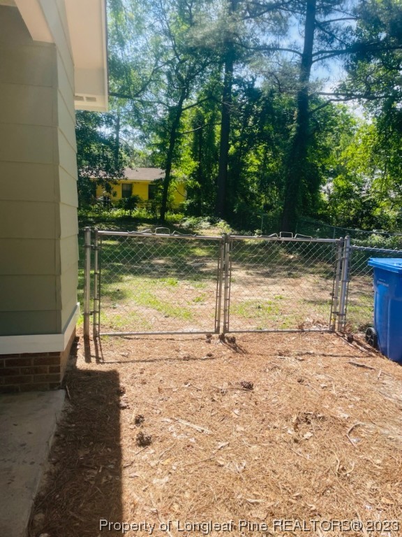 6442 Green Meadow Road Fayetteville, NC 28304 - Photo 43 of 48 a view of a yard with wooden fence