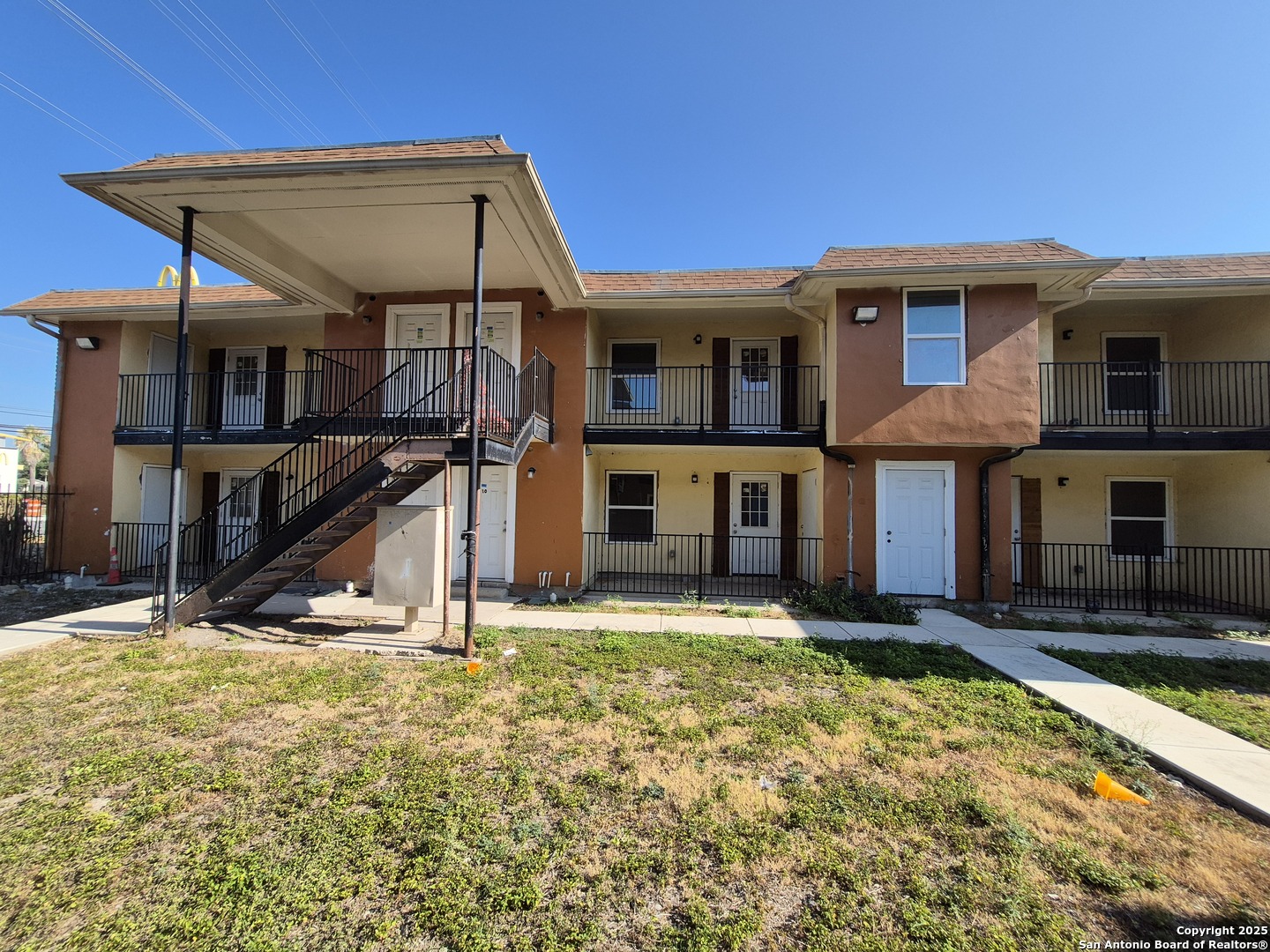 3718 Pleasanton Road, Unit 2103 San Antonio, TX 78221 - Photo 1 of 7 a view of a house with large windows and a small yard
