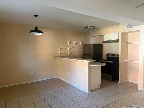 a kitchen with a refrigerator sink and cabinets