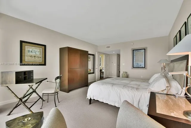 a bedroom with a bed and chair