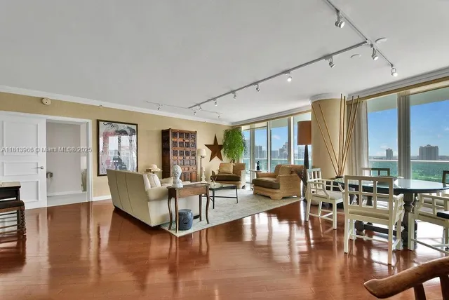 a living room with fireplace furniture and a large window