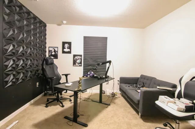 a bedroom with a bed and a desk