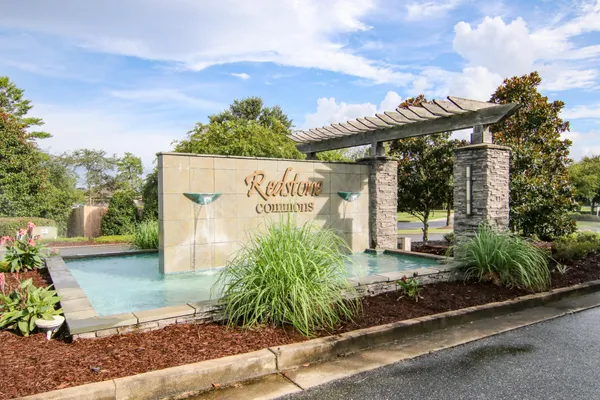 a view of a swimming pool and lounge chairs in patio
