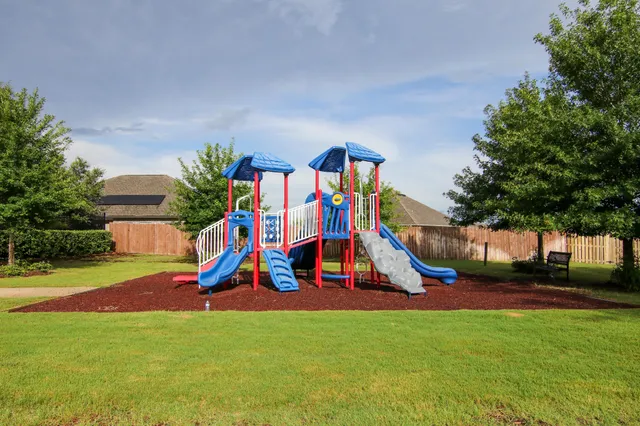 a view of a yard with wooden fence